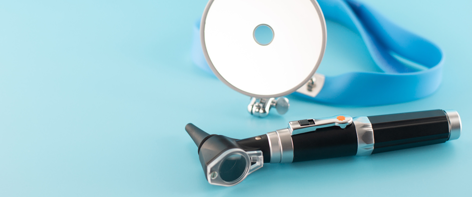 Ear professional instrument on blue background.